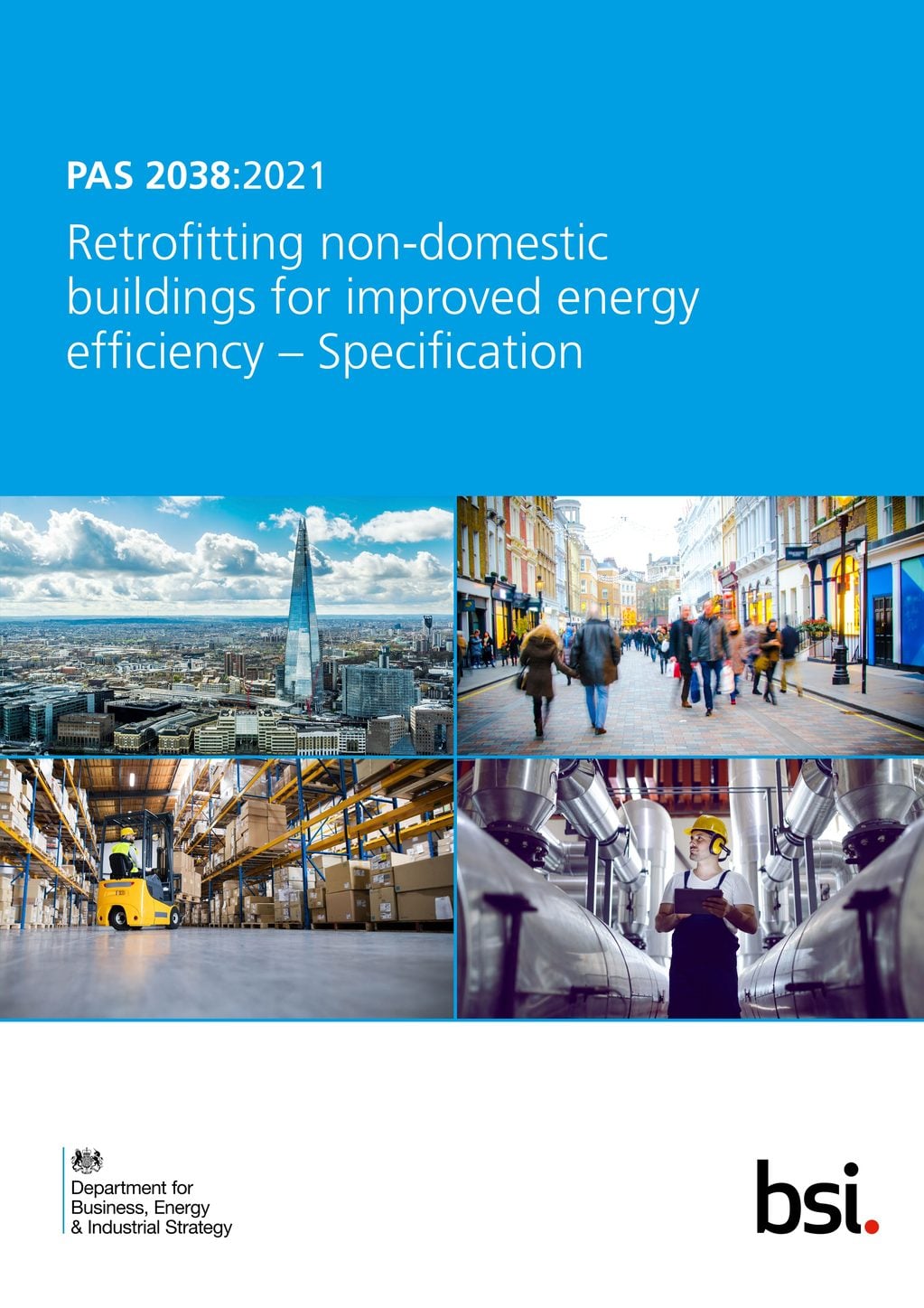 Blue cover page for PAS 2038:2021, with four photos below the title: an aerial view of a city skyline including the Shard, a busy pedestrianised shopping street, a warehouse interior with a forklift among stacked pallets, and a hi-vis worker with a tablet standing among industrial pipework. The BEIS and BSI logos appear at the bottom.