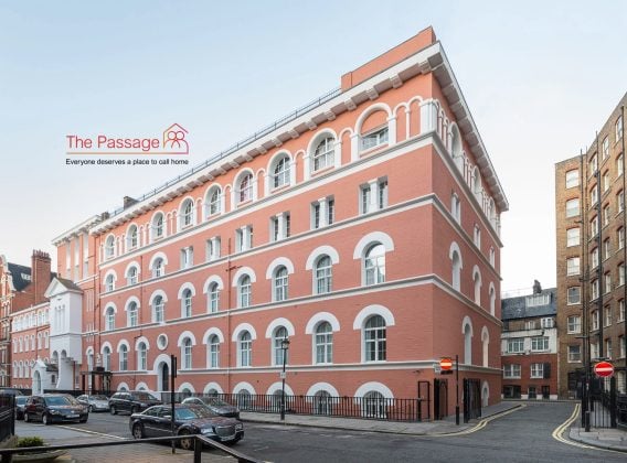 The exterior of The Passage's Bentley House in London, a large, five-story corner building with terracotta brickwork and white arched windows - MEES report case study