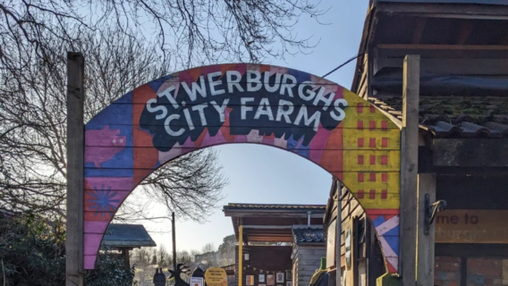 Colourful painted archway entrance sign for St Werburgh's City Farm in Bristol