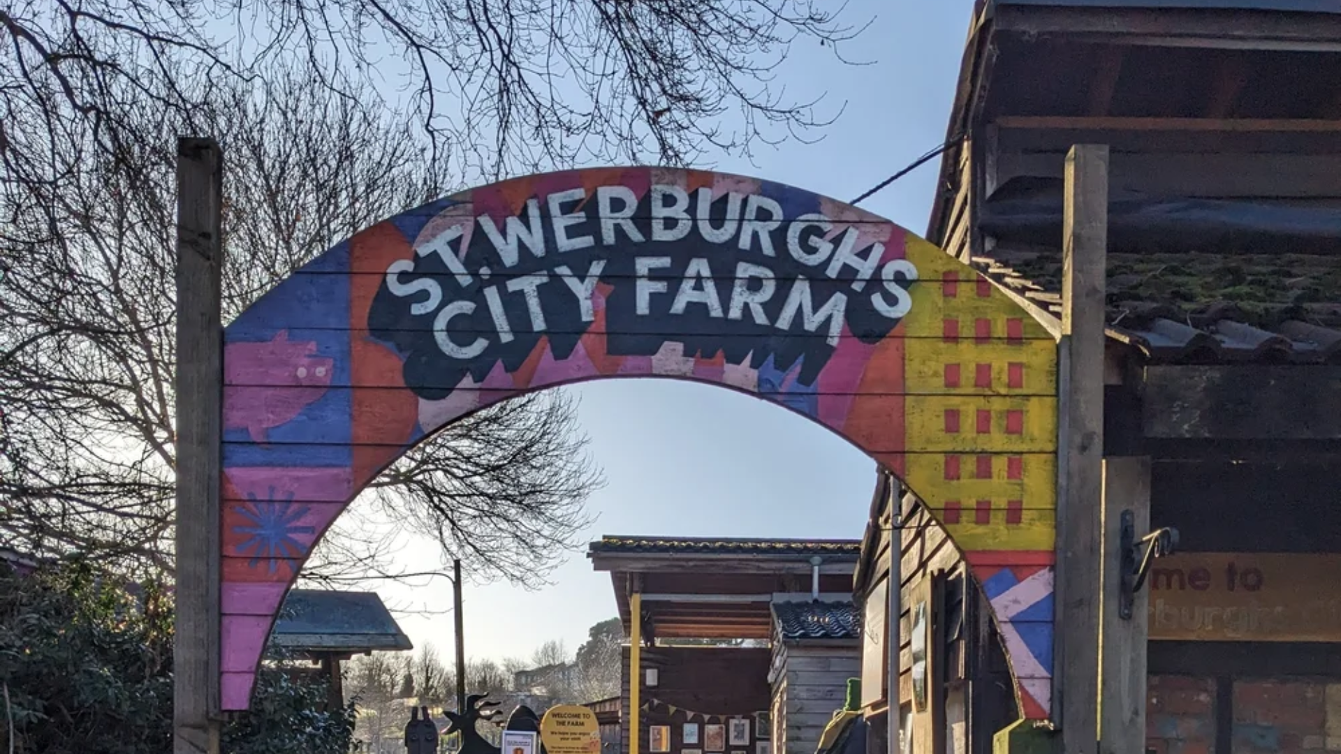 Colourful painted archway entrance sign for St Werburgh's City Farm in Bristol